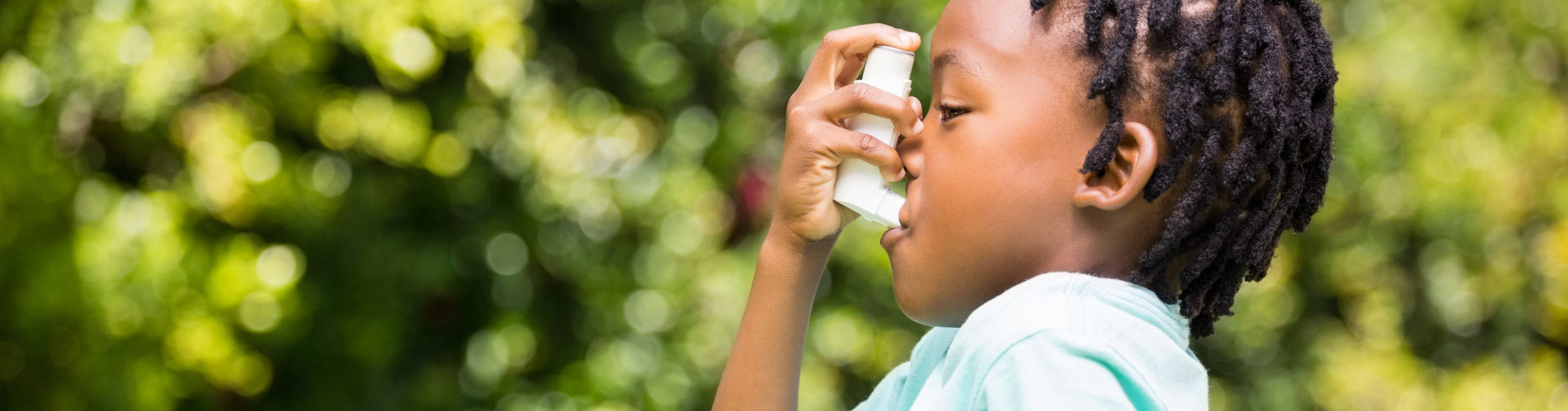 Boy using an asthma inhaler